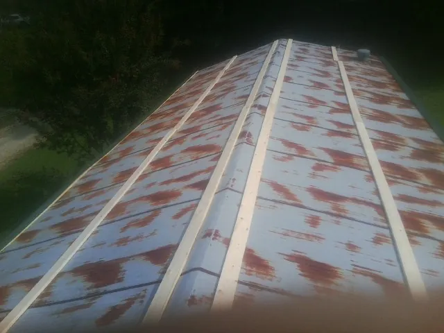 Rusted metal roof panels with new wood purlins before replacement — Storm Damage Roof Repair in Hamel by Roofing Brothers
